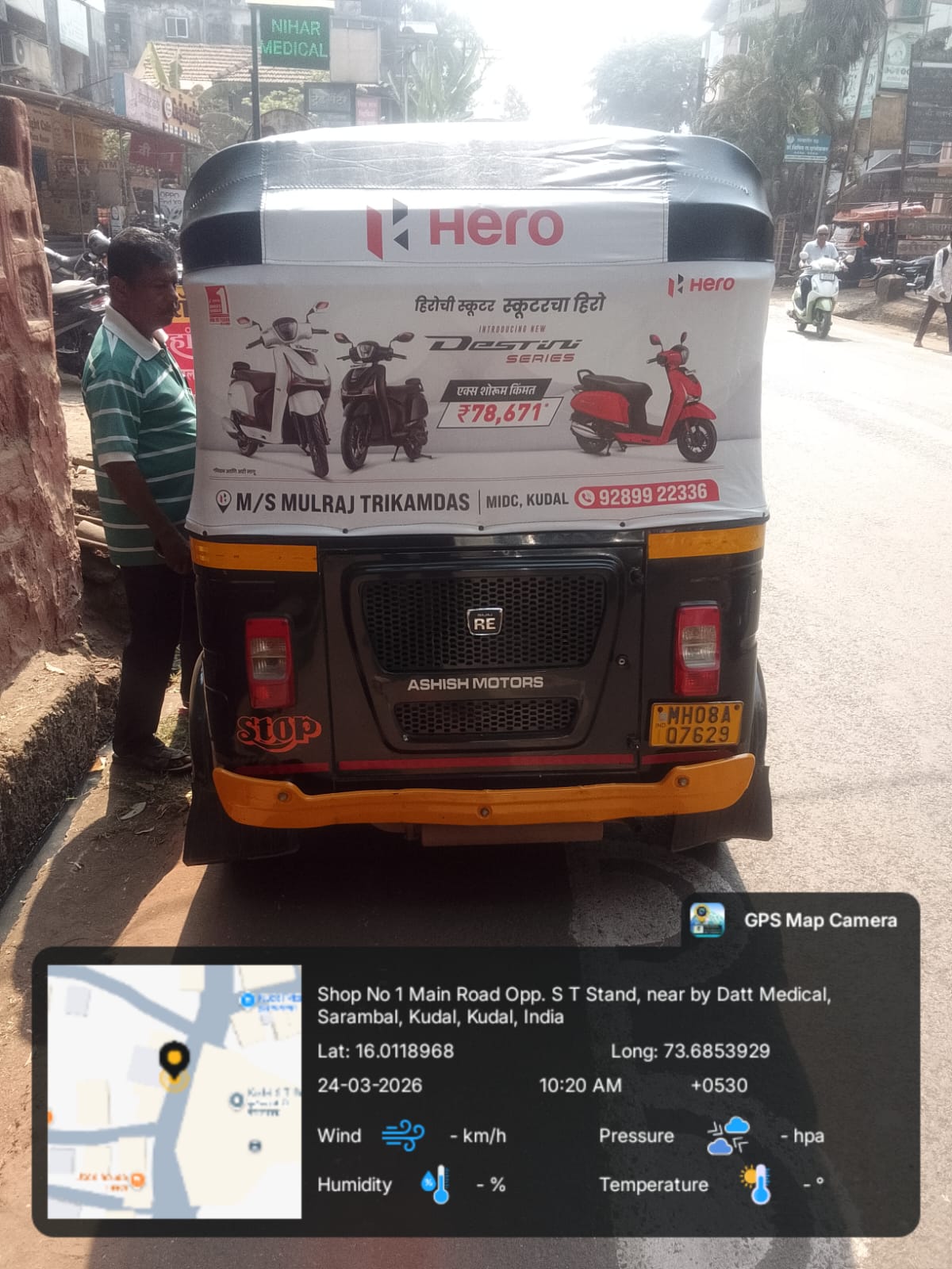 Branded auto rickshaw with hood advertising near the Ameerpet coaching hub in Hyderabad amid student foot traffic